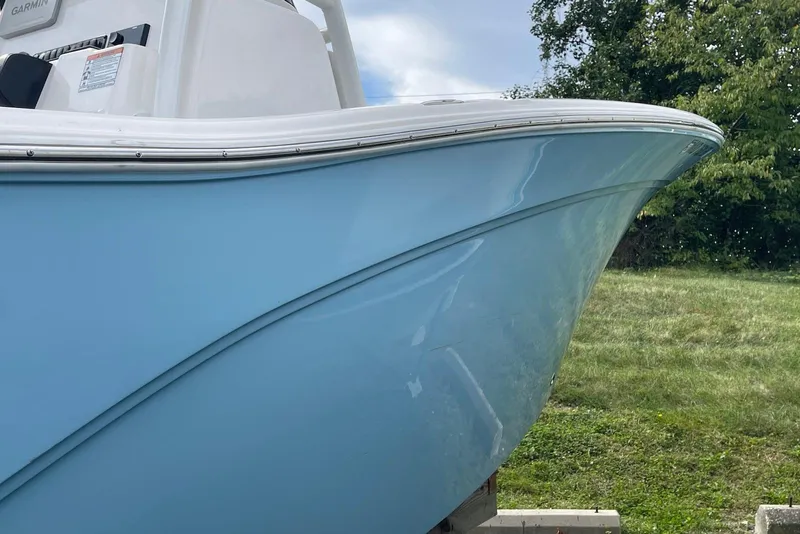 Slide: The Image of 2022 Sea Fox 228 Commander boat with light blue hull, parked on grass. - 61