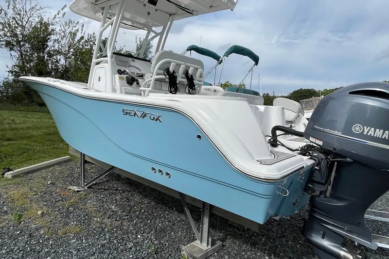 Slide: The Image of 2022 Sea Fox 228 Commander boat with Yamaha engine, displayed outdoors on gravel. - 7
