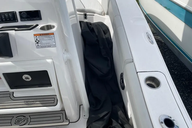 Slide: The Image of 2022 Sea Fox 228 Commander boat interior with cup holders and storage compartments. - 74