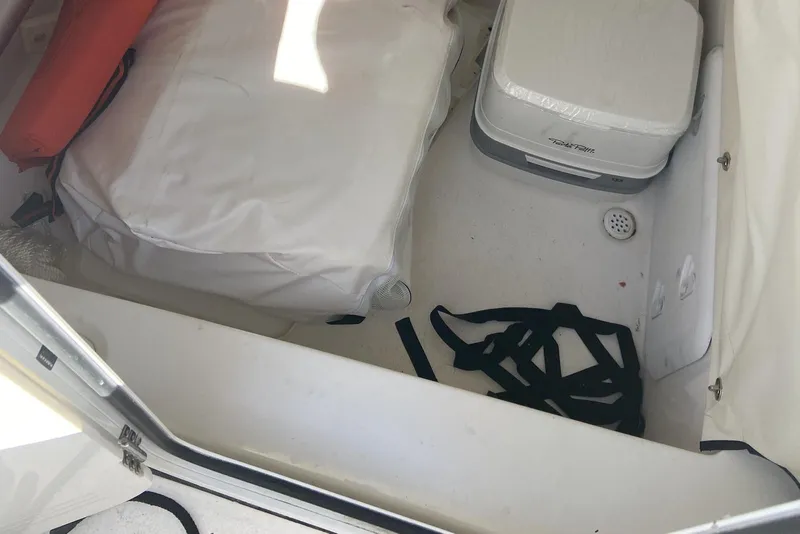 Slide: The Image of Interior storage of 2022 Sea Fox 228 Commander boat with life jacket and portable toilet. - 76
