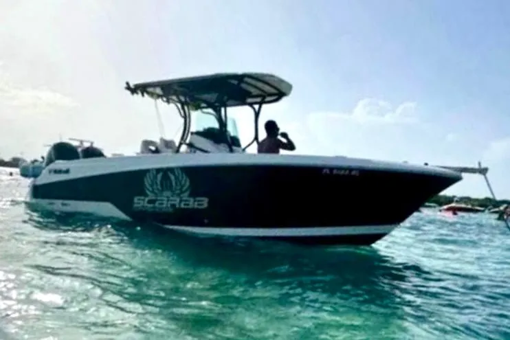 Slide: The Image of 2017 Wellcraft 262 Scarab Offshore boat on clear blue water, side view. - 4