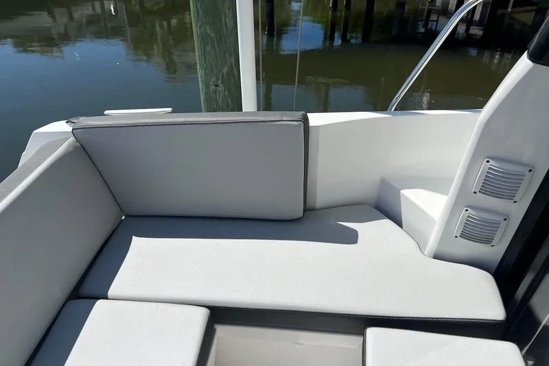 Slide: The Image of 2024 Jeanneau NC Weekender 895 interior seating area with gray cushions. - 10