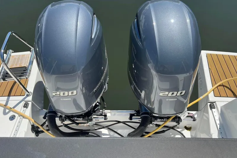 Slide: The Image of Twin Yamaha 200 engines on a 2024 Jeanneau NC Weekender 895 boat. - 11