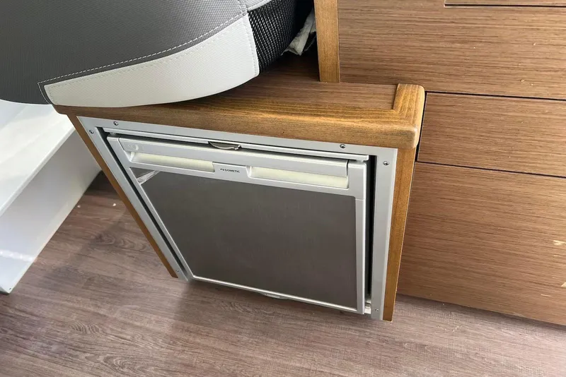 Slide: The Image of Compact fridge in 2024 Jeanneau NC Weekender 895 boat interior. - 13