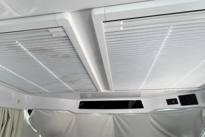 Slide: The Image of Interior ceiling view of 2024 Jeanneau NC Weekender 895 with modern design and lighting. - 20