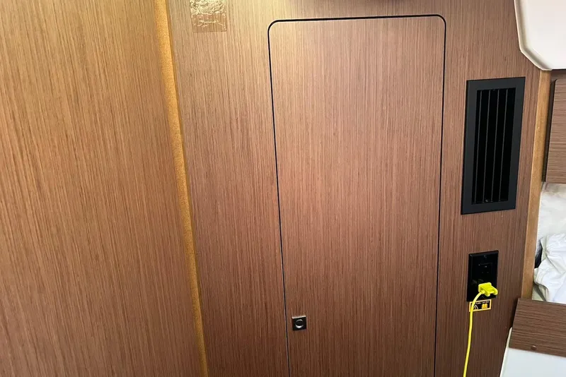 Slide: The Image of 2024 Jeanneau NC Weekender 895 interior with wood paneling and ventilation. - 22