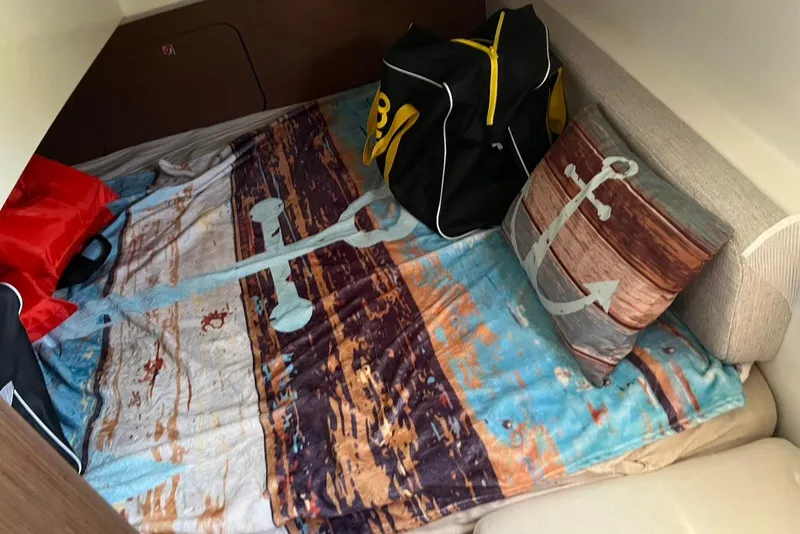 Slide: The Image of Cozy cabin interior of 2024 Jeanneau NC Weekender 895 with nautical-themed decor. - 23