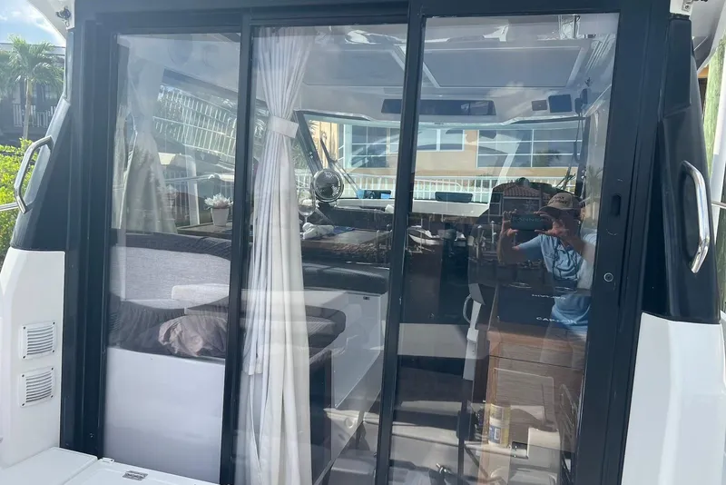 Slide: The Image of 2024 Jeanneau NC Weekender 895 interior view through glass doors. - 24