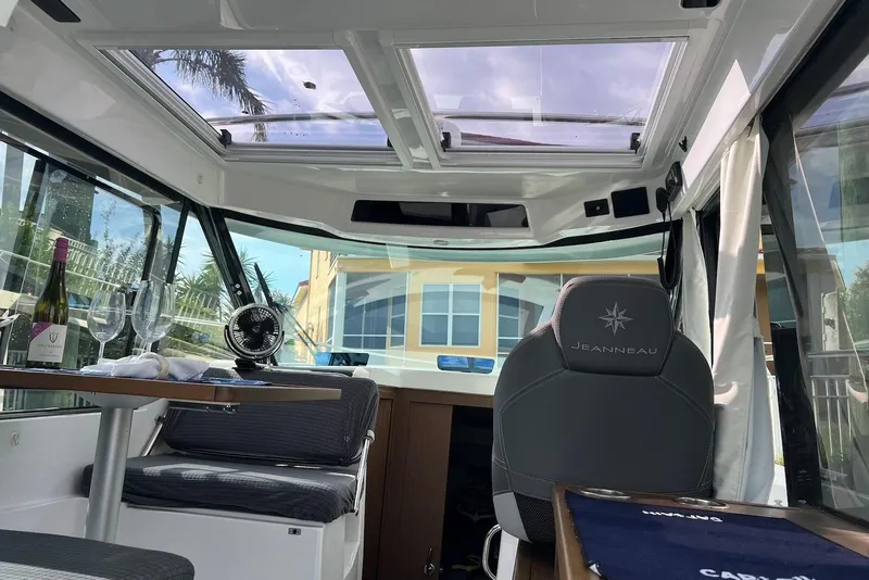 Slide: The Image of 2024 Jeanneau NC Weekender 895 interior with skylight, table, and seating. - 26