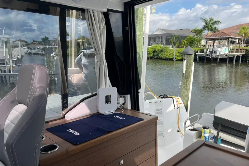 Slide: The Image of Interior view of 2024 Jeanneau NC Weekender 895, showcasing sleek design and waterfront scenery. - 31