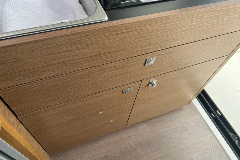 Slide: The Image of Wooden cabinetry in the 2024 Jeanneau NC Weekender 895 boat interior. - 33