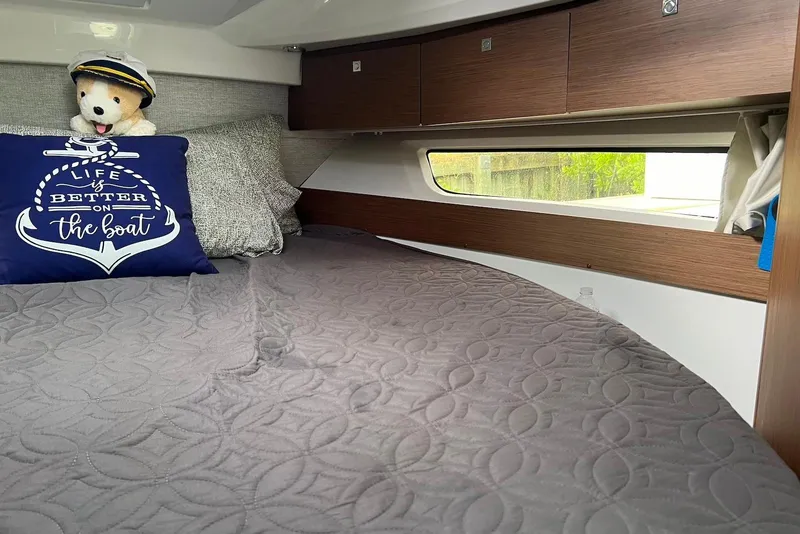 Slide: The Image of Cozy cabin interior of 2024 Jeanneau NC Weekender 895 with nautical decor and plush bedding. - 36