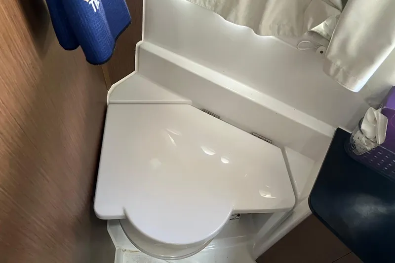Slide: The Image of 2024 Jeanneau NC Weekender 895 boat bathroom with compact toilet design. - 37