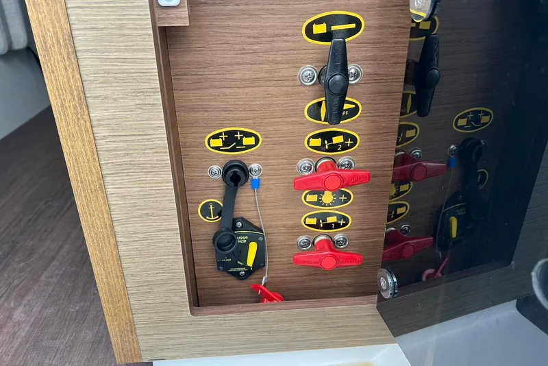 Slide: The Image of 2024 Jeanneau NC Weekender 895 control panel with switches and indicators. - 40