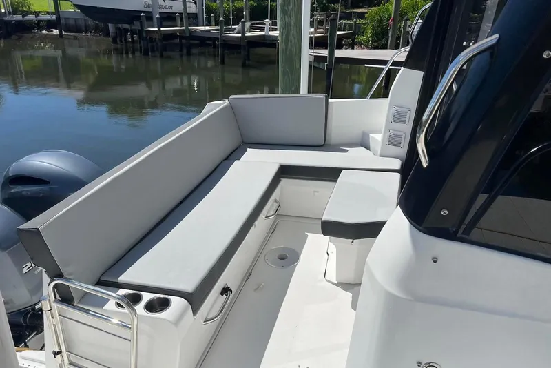 Slide: The Image of 2024 Jeanneau NC Weekender 895 boat with cushioned seating area and sleek design. - 6