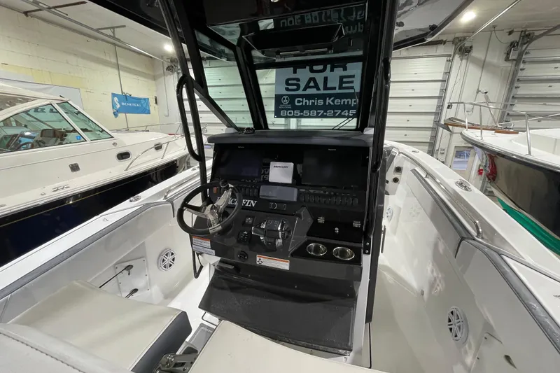 Slide: The Image of 2019 Blackfin 272 CC boat interior with steering console, for sale sign visible. - 18