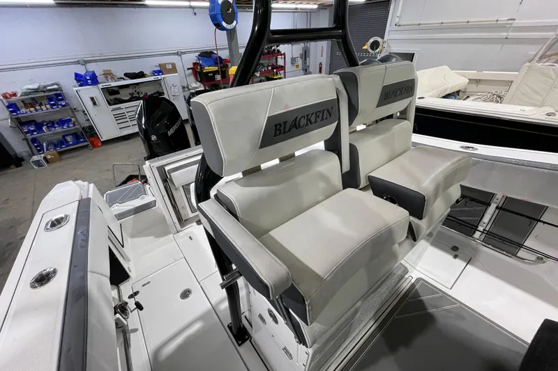 Slide: The Image of 2019 Blackfin 272 CC boat interior with dual seats in a workshop setting. - 23