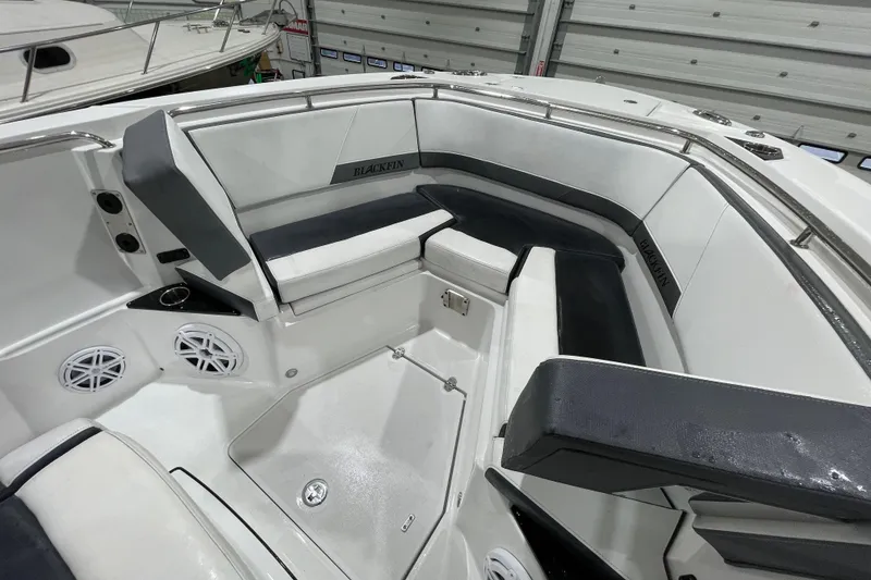 Slide: The Image of 2019 Blackfin 272 CC boat interior with cushioned seating and speakers. - 28