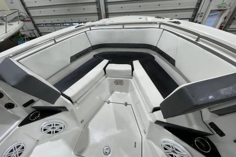 Slide: The Image of 2019 Blackfin 272 CC boat interior with cushioned seating and cup holders. - 29