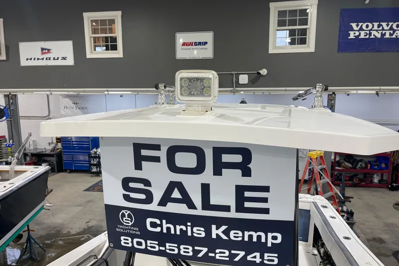 Slide: The Image of 2019 Blackfin 272 CC boat for sale in a showroom with contact details. - 34