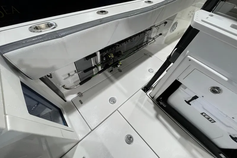 Slide: The Image of 2019 Blackfin 272 CC boat interior with fishing rod storage and Yeti cooler. - 35