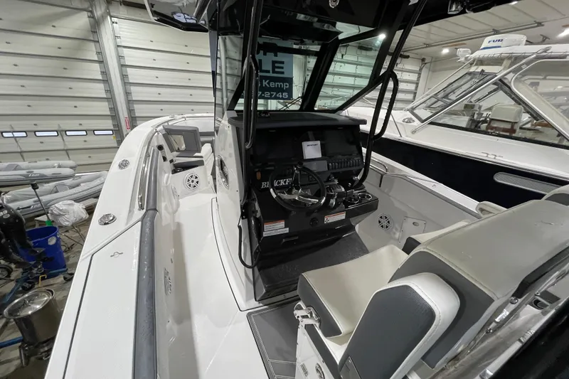 Slide: The Image of 2019 Blackfin 272 CC boat interior with helm and seating in a showroom. - 39
