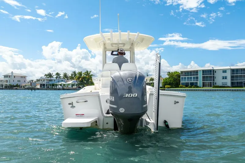 Slide: The Image of 2021 Regulator 26XO boat with Yamaha 300 engine on clear water, sunny day. - 13