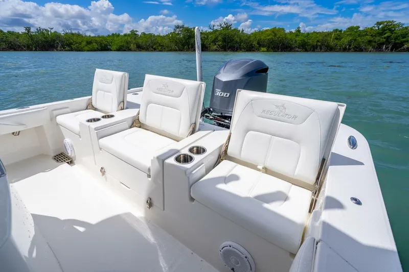 Slide: The Image of 2021 Regulator 26XO boat interior with white seating and Yamaha 300 engine. - 18