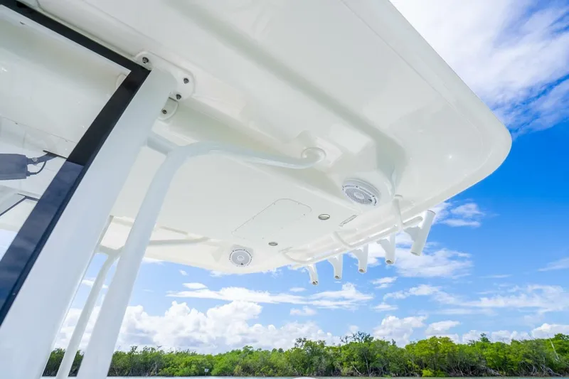 Slide: The Image of 2021 Regulator 26XO boat canopy against blue sky and clouds. - 24