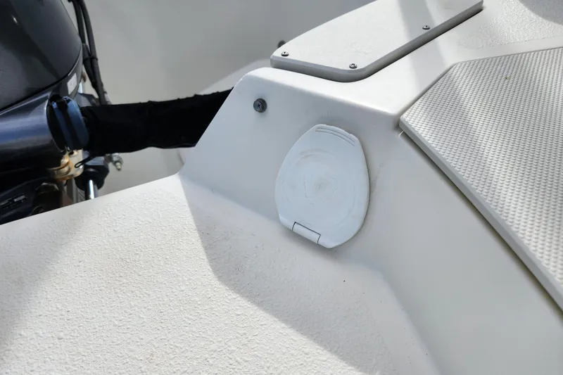 Slide: The Image of 2017 Stingray 214 LR boat detail showing engine and deck features. - 26