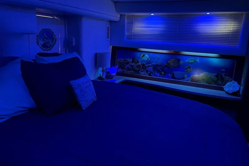 Slide: The Image of Cozy bedroom in 1997 Silverton 402 Motor Yacht with ambient blue lighting and aquarium. - 10
