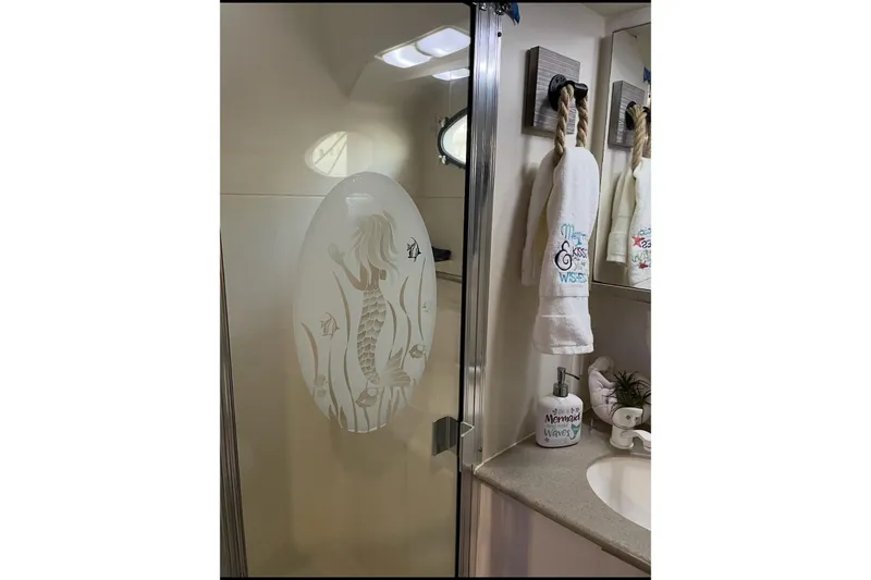 Slide: The Image of Bathroom of 1997 Silverton 402 Motor Yacht with mermaid-themed decor. - 11