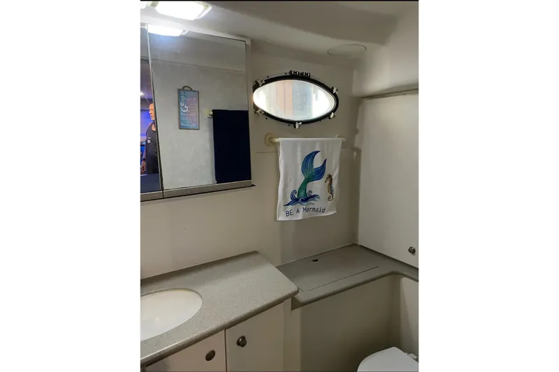 Slide: The Image of Bathroom interior of 1997 Silverton 402 Motor Yacht with mermaid-themed decor. - 12