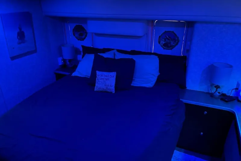 Slide: The Image of Cozy bedroom with blue lighting in a 1997 Silverton 402 Motor Yacht. - 13