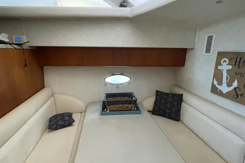 Slide: The Image of Interior of 1997 Silverton 402 Motor Yacht with cozy seating and nautical decor. - 14