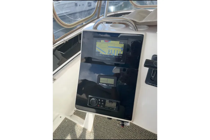 Slide: The Image of 1997 Silverton 402 Motor Yacht dashboard with navigation and control panels. - 20