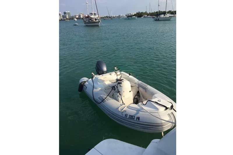 Slide: The Image of Inflatable boat docked on water near Silverton 402 Motor Yacht, 1997 model. - 25