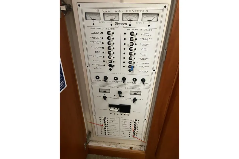 Slide: The Image of Electrical control panel of a 1997 Silverton 402 Motor Yacht, featuring 12V DC and 240V AC controls. - 26