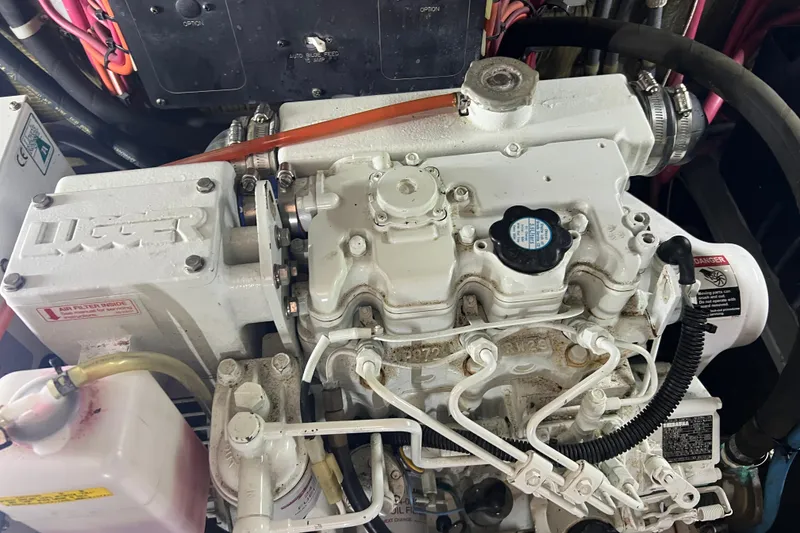 Slide: The Image of Engine of a 1997 Silverton 402 Motor Yacht, showcasing mechanical components and wiring. - 28