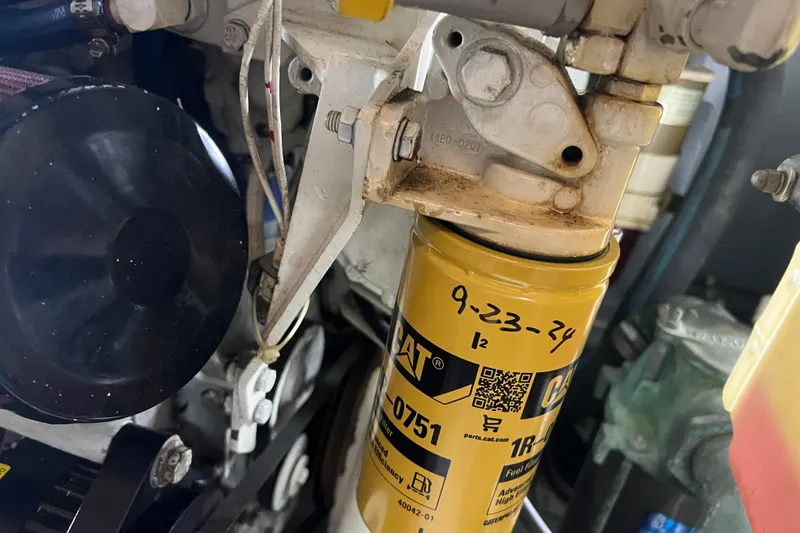 Slide: The Image of Engine component of a 1997 Silverton 402 Motor Yacht with CAT filter and handwritten date. - 29