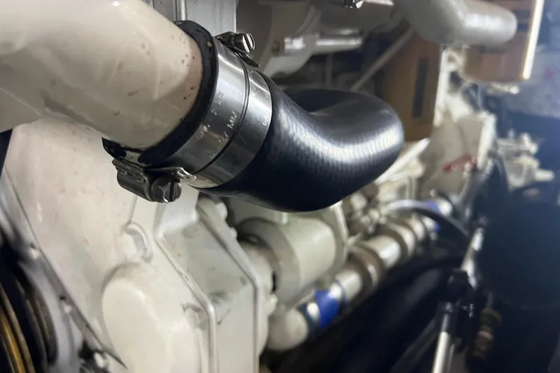 Slide: The Image of Engine detail of a 1997 Silverton 402 Motor Yacht, featuring hoses and clamps. - 30