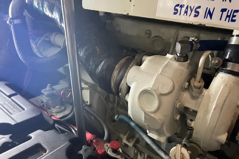 Slide: The Image of Engine compartment of a 1997 Silverton 402 Motor Yacht, showing mechanical components and hoses. - 32