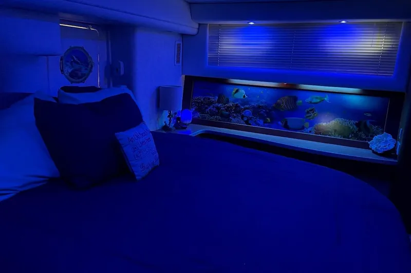 Slide: The Image of Luxurious 1997 Silverton 402 Motor Yacht bedroom with ambient blue lighting and aquarium. - 9