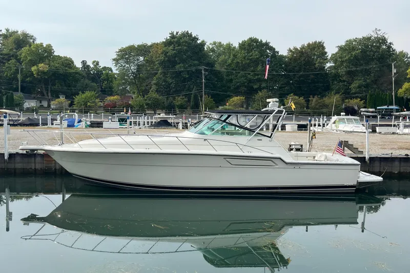 The Image of 1992 Tiara Yachts 4300 Open docked in a serene marina setting. - 0