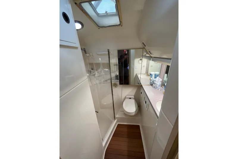 Slide: The Image of Bathroom interior of 1992 Tiara Yachts 4300 Open, featuring shower, toilet, and sink. - 12