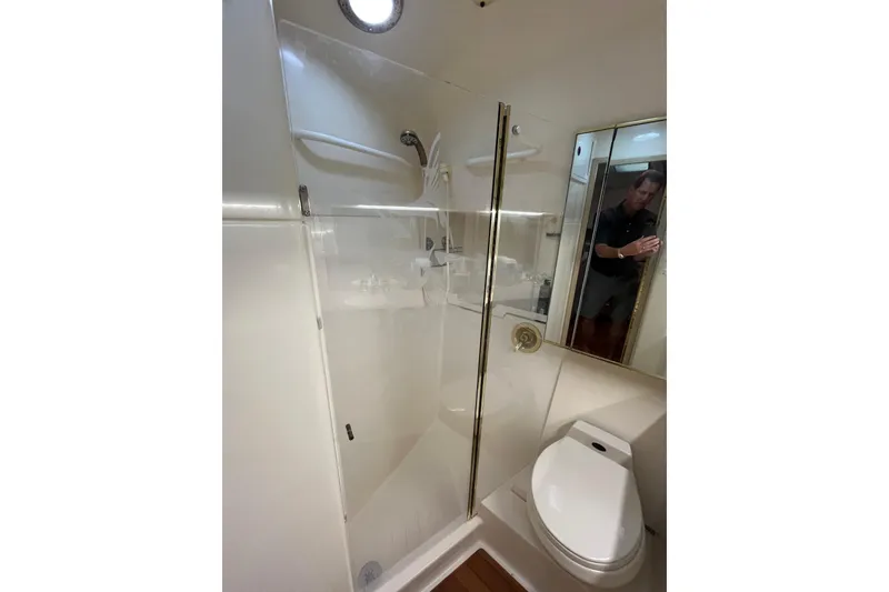 Slide: The Image of Bathroom interior of 1992 Tiara Yachts 4300 Open, featuring shower and toilet. - 13