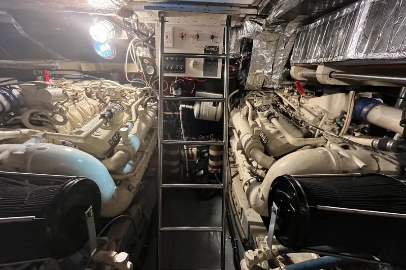 Slide: The Image of Engine room of a 1992 Tiara Yachts 4300 Open, featuring dual diesel engines. - 15