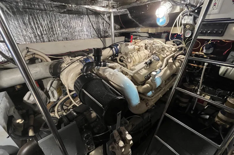 Slide: The Image of Engine room of a 1992 Tiara Yachts 4300 Open, featuring a well-maintained engine. - 17