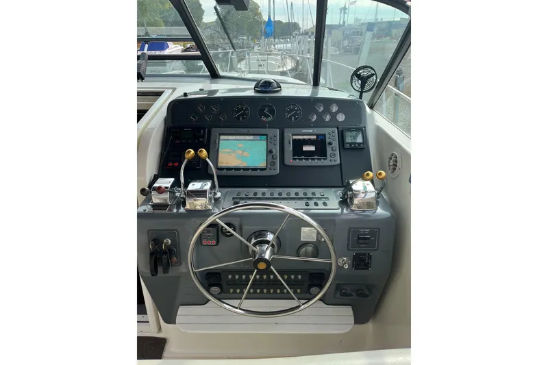 Slide: The Image of Helm of 1992 Tiara Yachts 4300 Open with navigation equipment and steering wheel. - 7