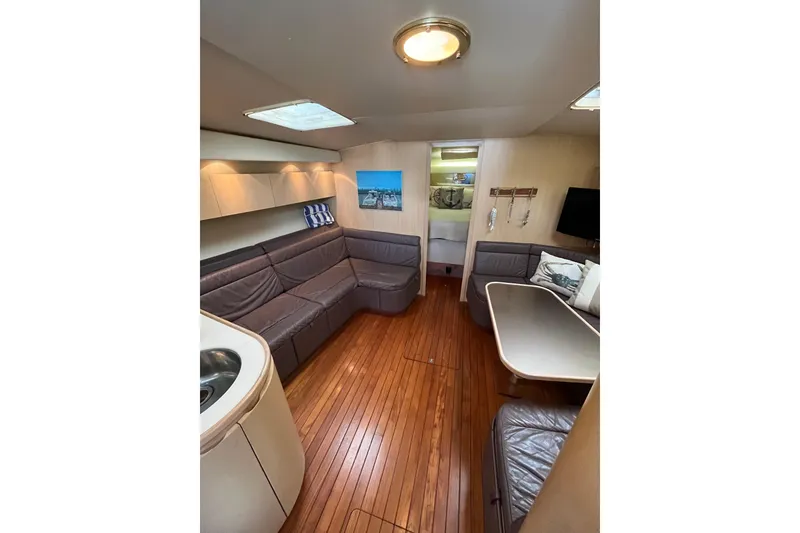 Slide: The Image of Interior of 1992 Tiara Yachts 4300 Open with wood flooring and leather seating. - 8